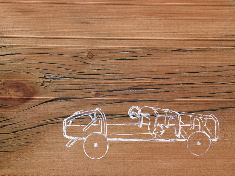 9a-a-line-drawing-image-of-a-car-on-a-natural-wood-gr-FLKVAPV-1-scaled